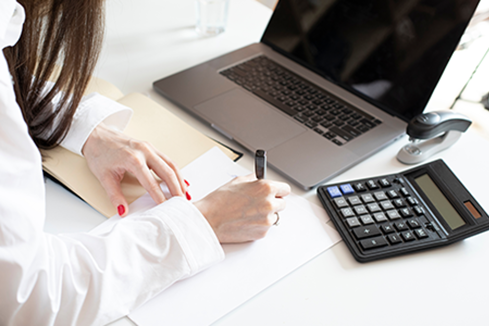 Woman taking financial notes